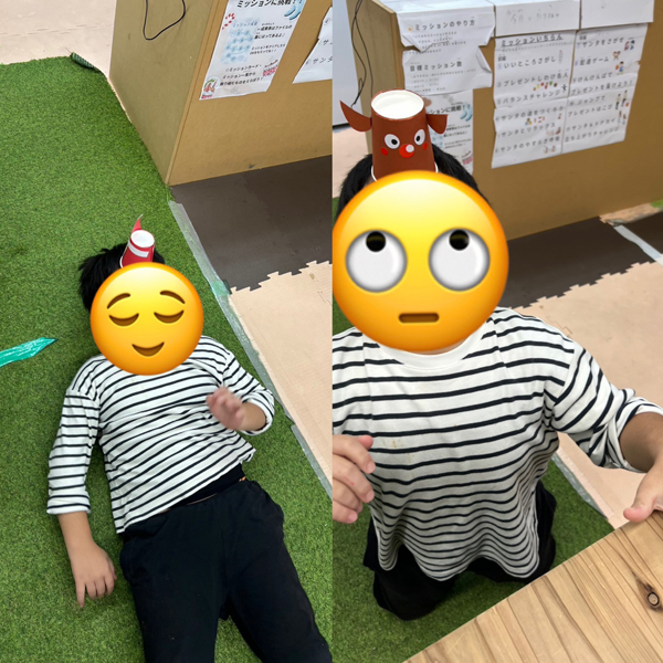 頭に紙コップを乗せたまま立ち上がることに挑戦する児童